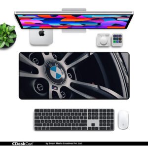 BMW M Performance Wheel desk mat — silver, black and blue design, available in M, L, XL and XXL sizes.