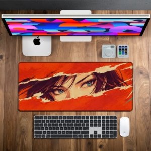 Crimson Gaze Desk Mat on a wooden desk with monitor, keyboard and mouse