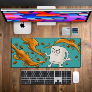 Grumpy Coffee Mug Desk Mat on a wooden desk with monitor, keyboard and mouse