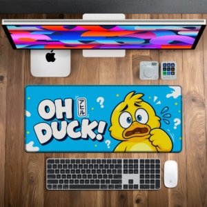 Oh Duck Desk Mat on a wooden desk with monitor, keyboard and mouse