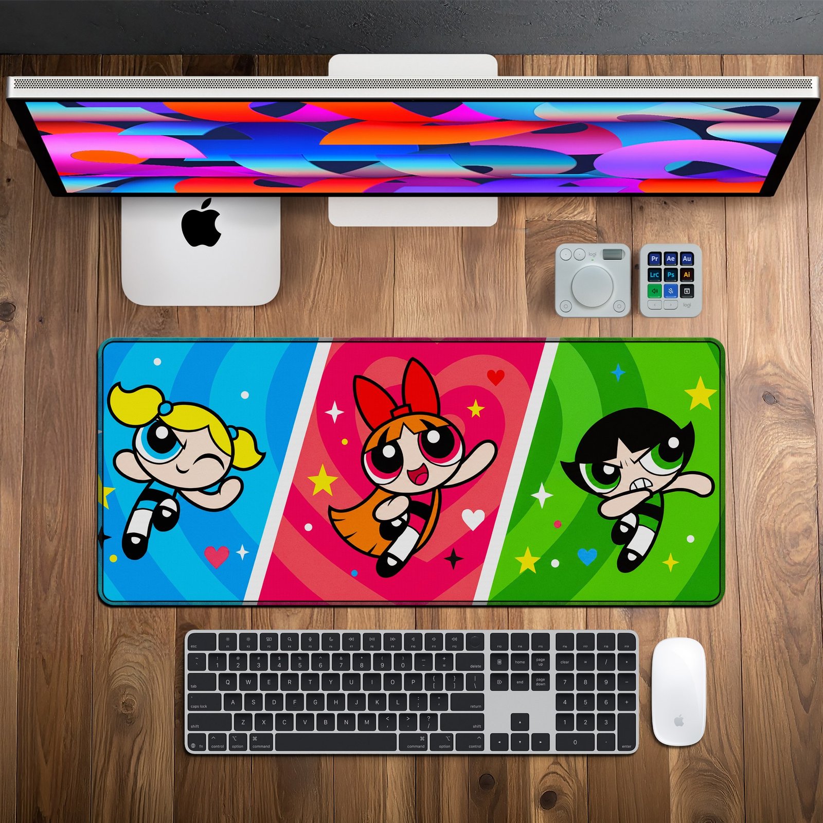 Super Trio Pop Desk Mat — blue, pink, green and yellow design, available in M, L and XL sizes. Super Trio Pop Desk Mat on a wooden desk with monitor, keyboard and mouse